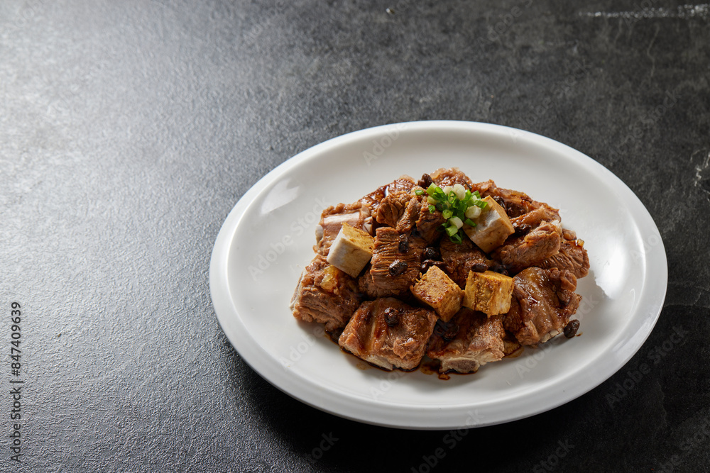 traditional chinese wok fried fat meat pork ribs chicken in spicy pepper and sweet sauce in plate on stone table hotel cafe luxury halal food restaurant banquet menu traditional chinese wok fried fat meat pork ribs chicken in spicy pepper and sweet sauce in plate on stone table hotel cafe luxury halal food restaurant banquet menu