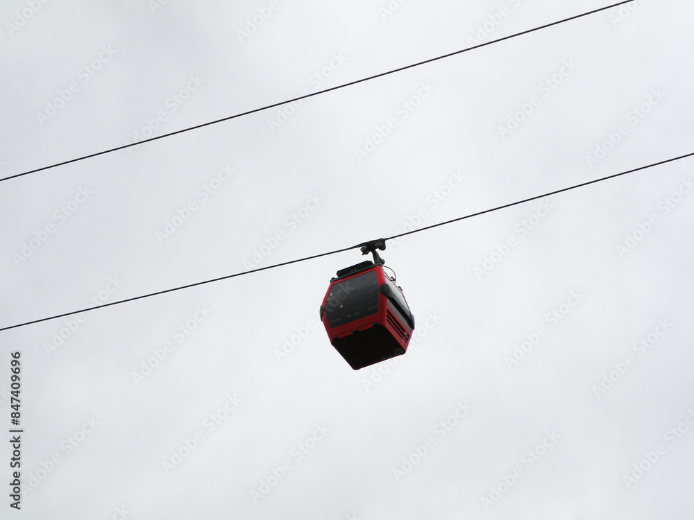 Red cable car cabin that transports people Red cable car cabin that transports people