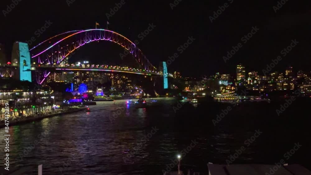 Colourful Light show at night on Sydney Harbour NSW Australia. The bridge illuminated with lasers and neon coloured lights Vivid Sydney Laser and Light Drone show Colourful Light show at night on Sydney Harbour NSW Australia. The bridge illuminated with lasers and neon coloured lights Vivid Sydney Laser and Light Drone show