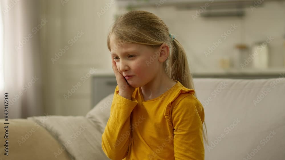 Unhappy little girl chewing eating touch cheek dental pain stomatology dentistry health child kid teeth ache caries discomfort disease toothache hurt ill oral mouth problem suffer dentist sofa home Unhappy little girl chewing eating touch cheek dental pain stomatology dentistry health child kid teeth ache caries discomfort disease toothache hurt ill oral mouth problem suffer dentist sofa home