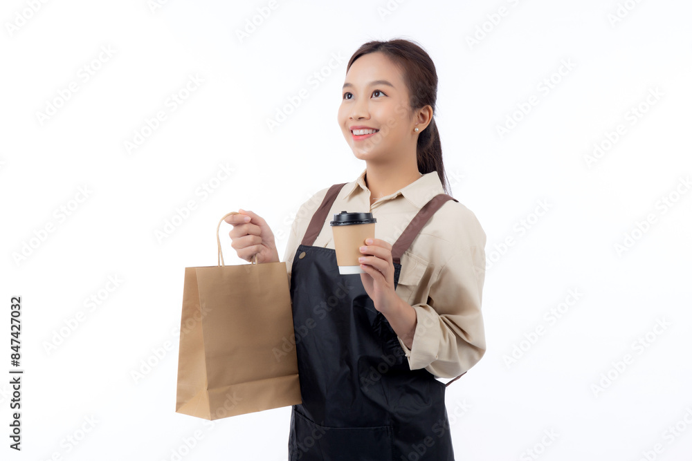 Young asian woman barista work attire happy holding a takeaway coffee cup and paper bag isolated white background, joyful barista presenting takeaway coffee with excited, small business or startup. Young asian woman barista work attire happy holding a takeaway coffee cup and paper bag isolated white background, joyful barista presenting takeaway coffee with excited, small business or startup.