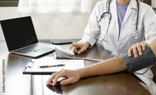 The female doctor measured blood pressure, the patient examined the heartbeat and sat down to talk about health care closely. health care concept