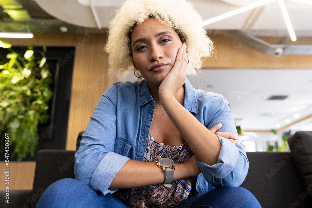 Biracial young woman on video call in business office Biracial young woman on video call in business office