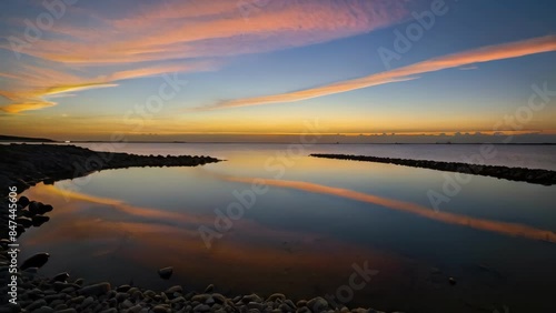 Calm Sunset Over a Coastal Inlet With Stunning Reflections