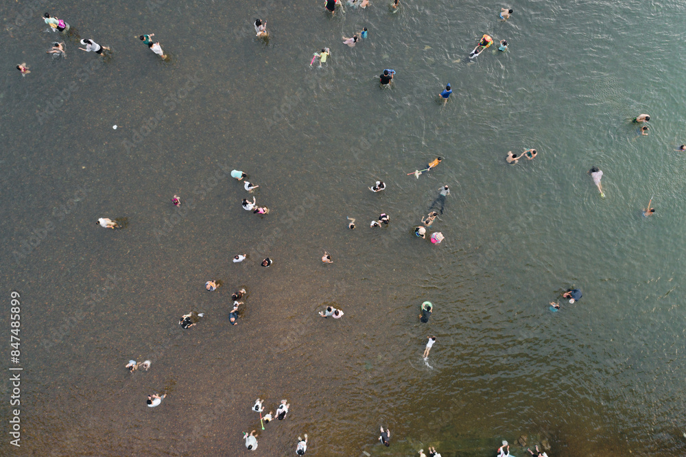 Overlooked people playing in the Li River shoal in summer Overlooked people playing in the Li River shoal in summer
