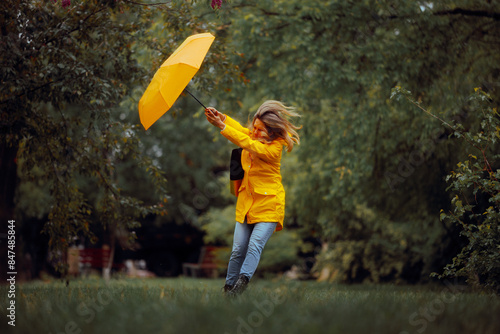 Woman Fighting Wind Blow During a Rainstorm Tempest. Strong windy bad weather being dangerous and risky
