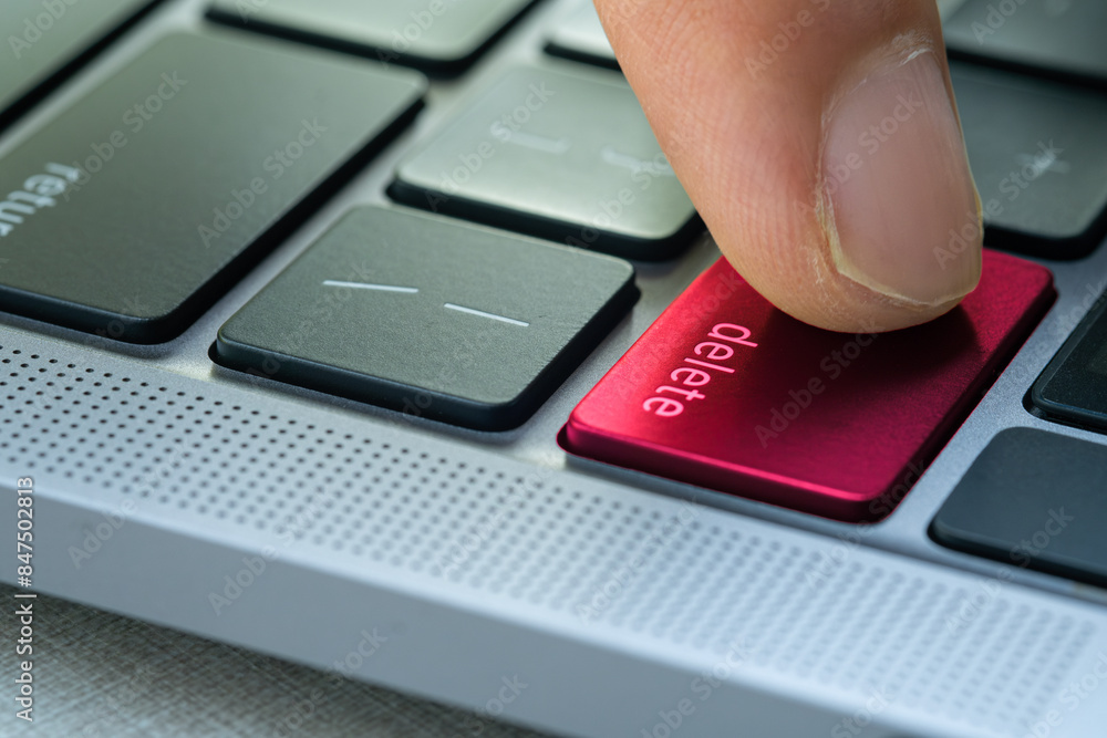 Finger of the computer user, he presses the delete button on the computer keyboard.
Finger of the computer user, he presses the delete button on the computer keyboard.