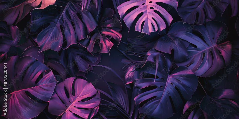Vibrant neon-colored tropical leaves in a dark background Vibrant neon-colored tropical leaves in a dark background