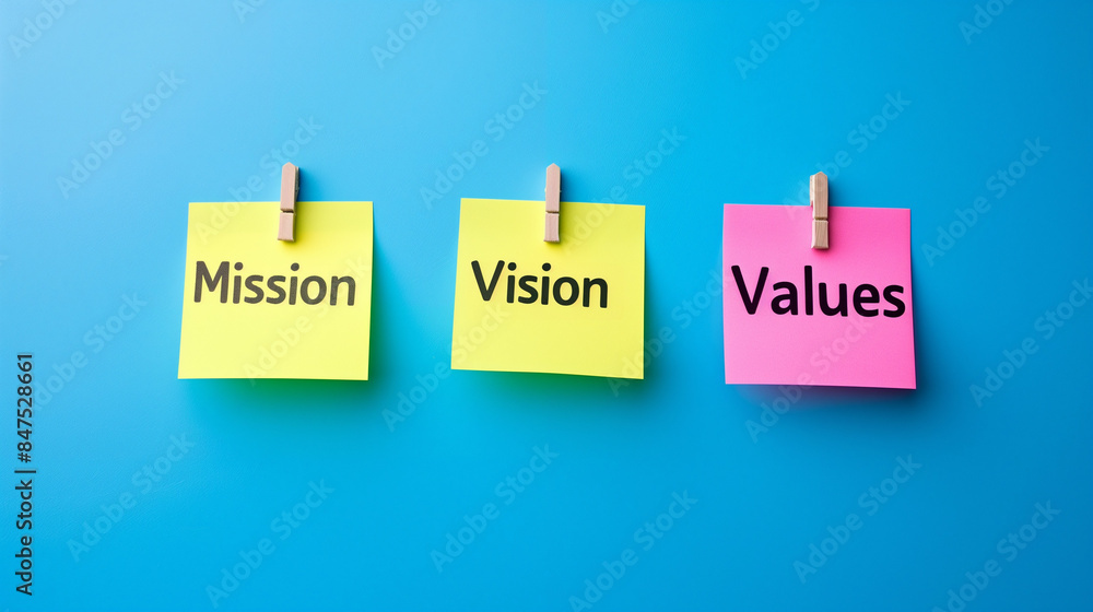 Mission vision values of company on sticky note isolated on blue background, Corporate goal strategy concept Mission vision values of company on sticky note isolated on blue background, Corporate goal strategy concept