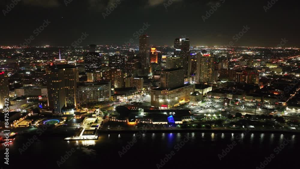 Vibrant nighttime beauty of New Orleans with this aerial view showcasing the illuminated cityscape, skyscraper of downtown area, and scenic waterfront Vibrant nighttime beauty of New Orleans with this aerial view showcasing the illuminated cityscape, skyscraper of downtown area, and scenic waterfront