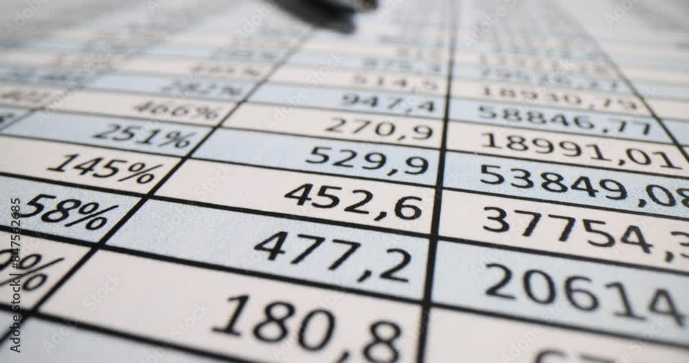 Spreadsheet with digits and metal pen on auditor workplace Spreadsheet with digits and metal pen on auditor workplace