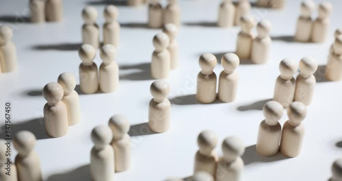 Single pawn stands among wooden figures couples on table photo