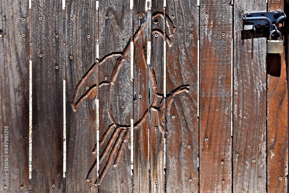A wood carved decoration similar to the Central American parrot found as a petroglyph at Petroglyph National Monument, Albuquerque, New Mexico A wood carved decoration similar to the Central American parrot found as a petroglyph at Petroglyph National Monument, Albuquerque, New Mexico