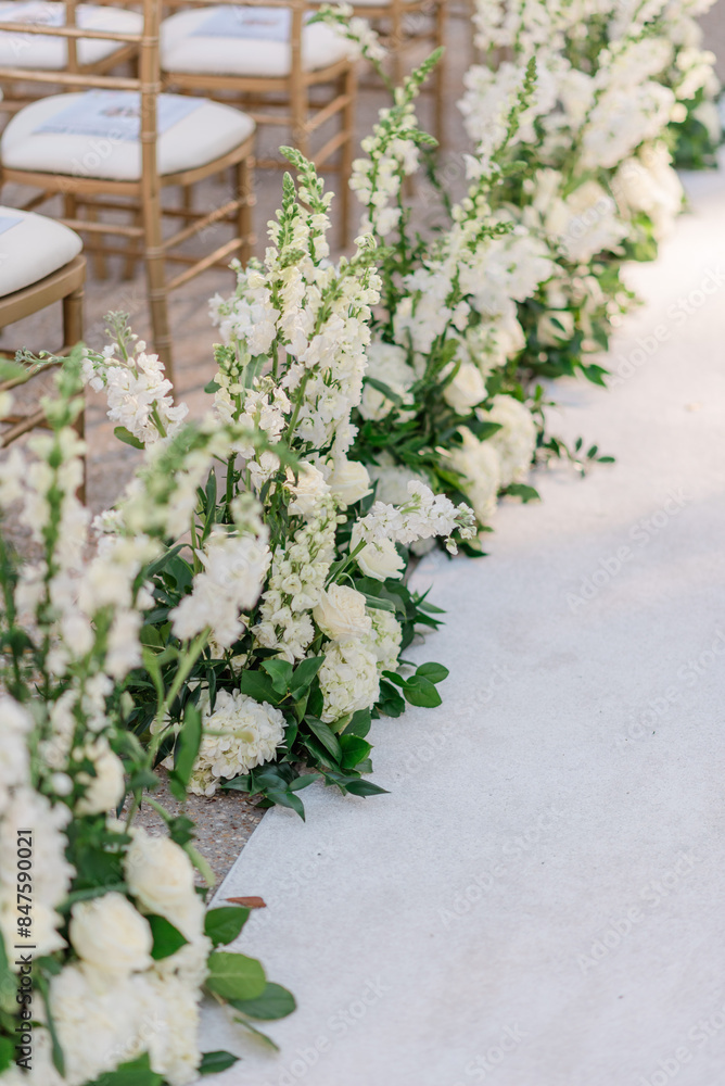 White floral design as aisle runner at wedding