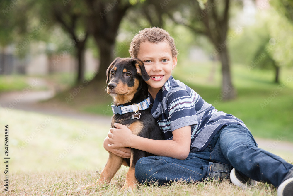 Boy hugging puppy and smiling at camera Boy hugging puppy and smiling at camera