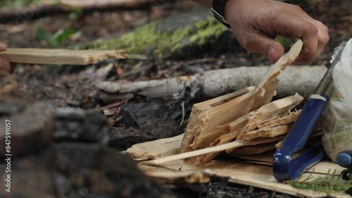 Men's hands pick wood for lighting a fire photo