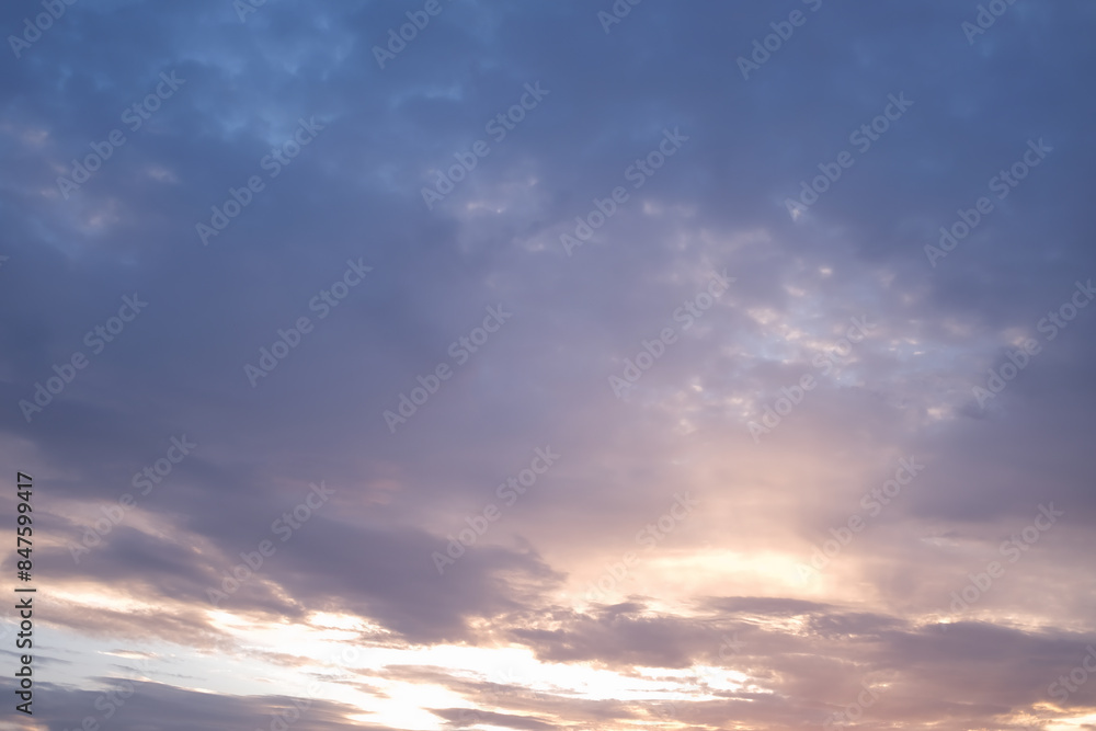 Soft blue sky combines with light of sunset to create a peaceful sky. Beautiful landscape with clouds and orange sun. Soft blue sky combines with light of sunset to create a peaceful sky. Beautiful landscape with clouds and orange sun.