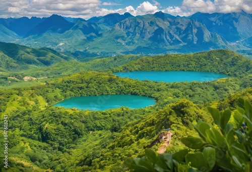 Aerial view of a lush green valley with two large blue lakes nestled among the verdant hills.