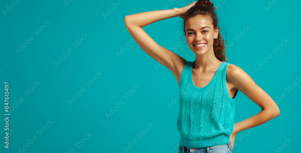 Smiling young woman in casual attire against vibrant teal background. cheerful expression radiates positivity. copy space or design. lifestyle, fashion, or advertising content Smiling young woman in casual attire against vibrant teal background. cheerful expression radiates positivity. copy space or design. lifestyle, fashion, or advertising content