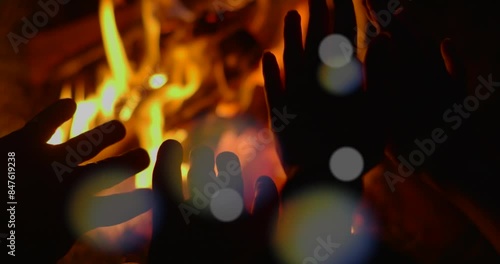 People warm their hands by the fire. night time