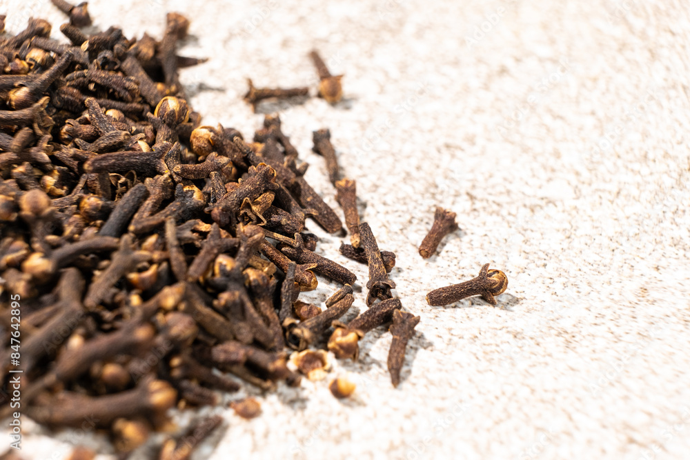 Dried clove spice on a gray stone background, macro Dried clove spice on a gray stone background, macro