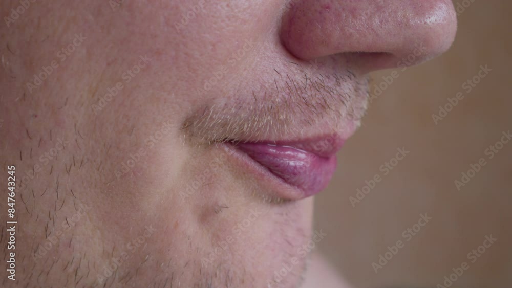 A man enjoys drinking a drink from a mug. Close-up. A man enjoys drinking a drink from a mug. Close-up.