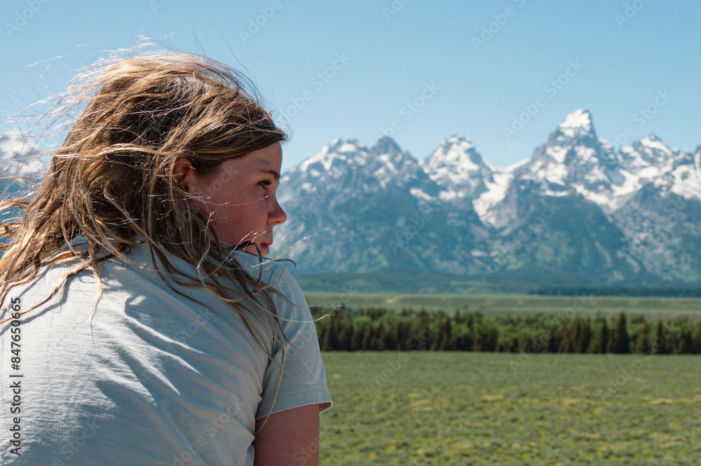 Profile of boy with Teton mountain range during summer Profile of boy with Teton mountain range during summer