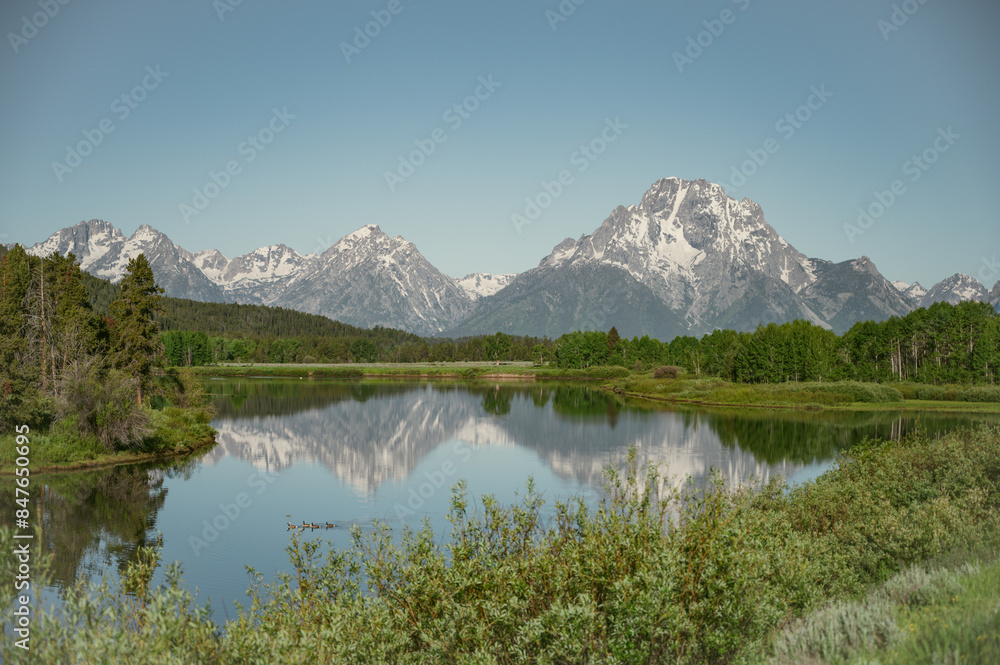 Morning view of Grand Teton National Park reflecting on water Morning view of Grand Teton National Park reflecting on water