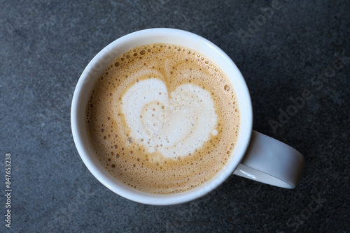 A cup with a caffe latte on a table photo