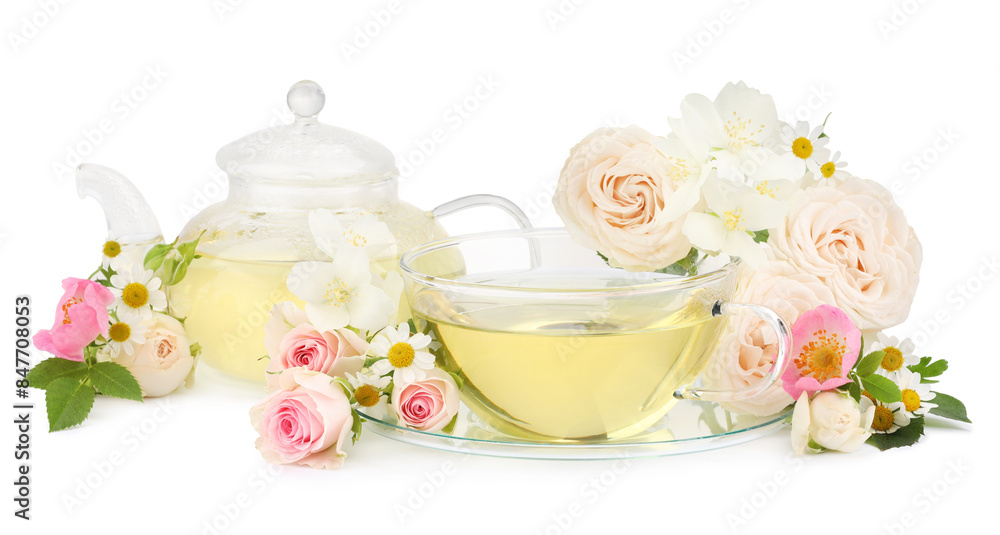 Aromatic herbal tea in glass cup, teapot and flowers isolated on white Aromatic herbal tea in glass cup, teapot and flowers isolated on white