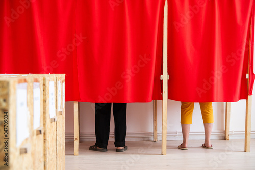 People vote in polling booths during elections.