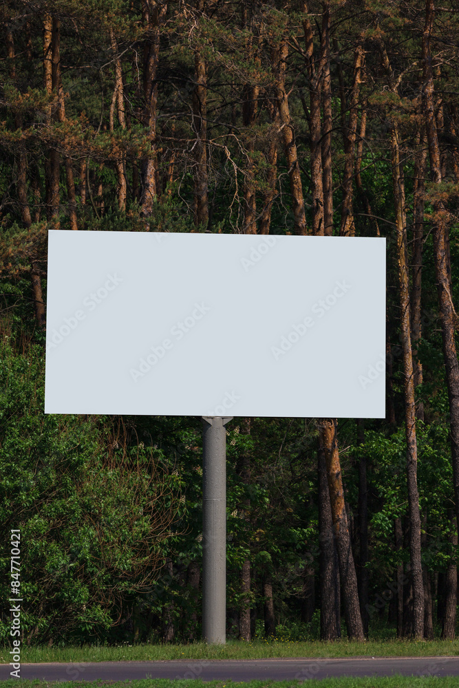 White billboard along the highway. Background for design and advertising. White billboard along the highway. Background for design and advertising.