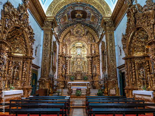 The intricate golden interior of the Carmelite church Igreja do Carmo in the old town of Faro in Portugal