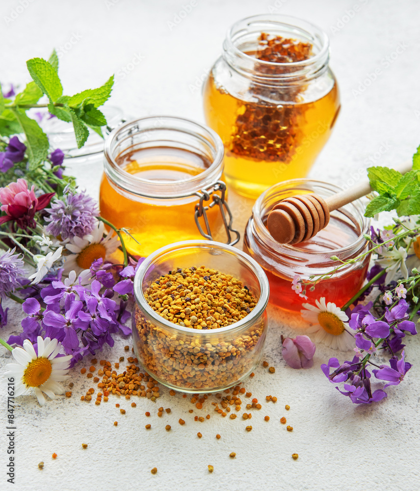 Raw organic bee pollen and honey in jars. Raw organic bee pollen and honey in jars.