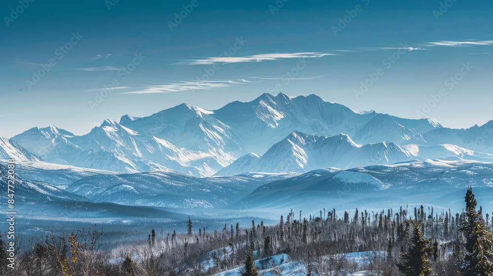 Snow-covered Mt. Denali and Alaskan mountain range under clear sky Snow-covered Mt. Denali and Alaskan mountain range under clear sky