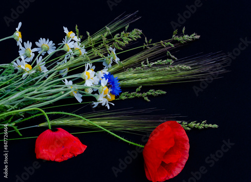 floral arrangement of red poppies, daisies, cornflowers and wildflowers