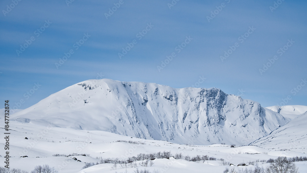 Obraz premium Norwegian high mountains in the snow. Mountains covered with snow. Scandinavia