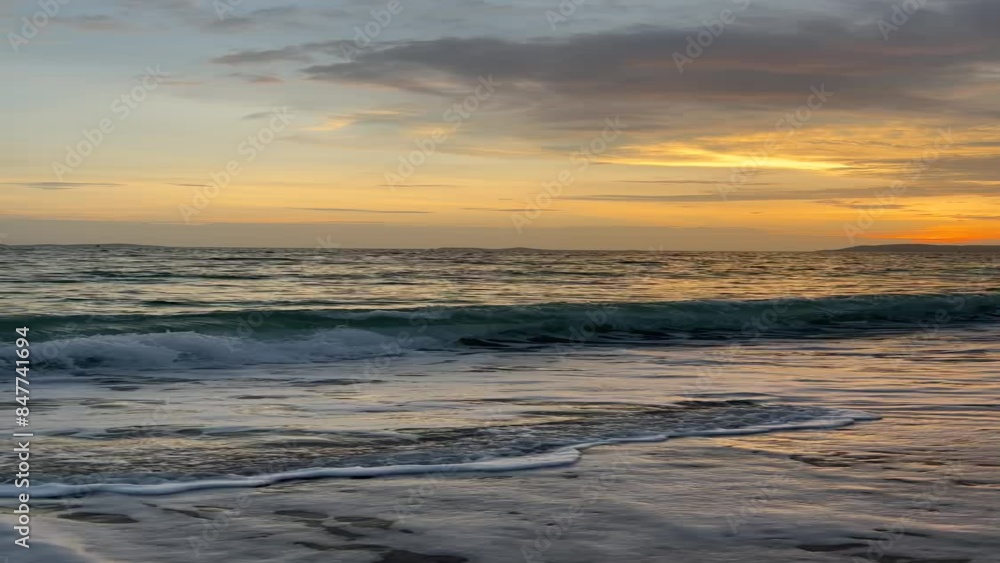 Vibrant sunset casting a golden glow over ocean waves crashing onto a sandy beach, with dramatic clouds in the sky.
Vibrant sunset casting a golden glow over ocean waves crashing onto a sandy beach, with dramatic clouds in the sky.