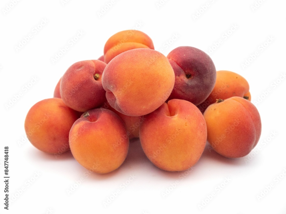 Pile of fresh apricots isolated on a white background. Pile of fresh apricots isolated on a white background.