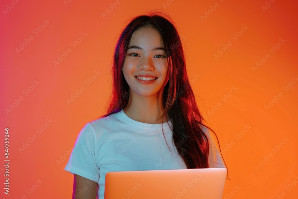 Young student enjoying student life with laptop in neon light. Young student enjoying student life with laptop in neon light.