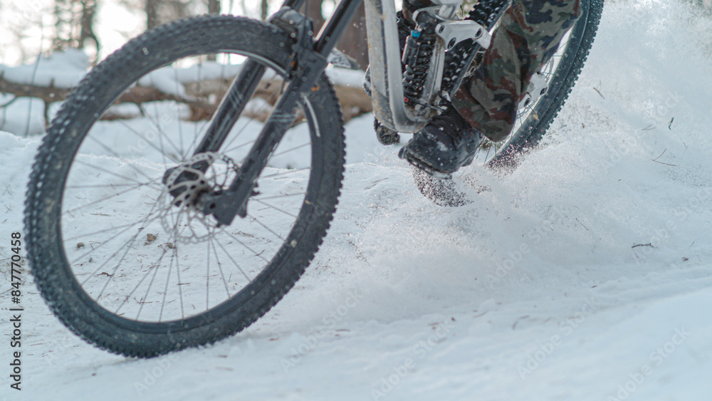 CLOSE UP: Winter mountain biking at adrenaline-filled snow-covered forest trail CLOSE UP: Winter mountain biking at adrenaline-filled snow-covered forest trail