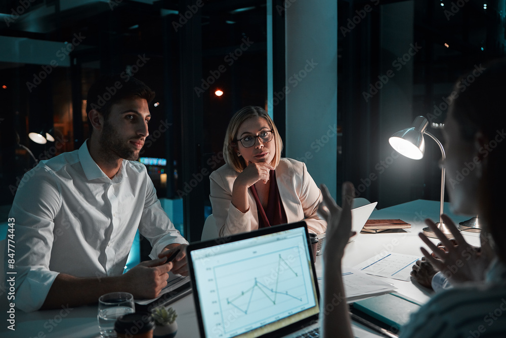 Employee, teamwork and laptop in office at night with documents for deadline or overtime as accountant. People, partnership and feedback or explain for financial reviews, records and graph on screen Employee, teamwork and laptop in office at night with documents for deadline or overtime as accountant. People, partnership and feedback or explain for financial reviews, records and graph on screen