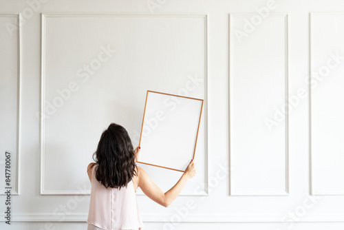 Принти на полотні Picture frame png mockup, woman decorating wall, transparent design