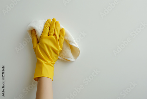 a hand in rubber gloves holding a cloth for cleaning