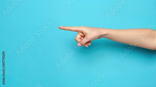 A close-up shot of a businesswoman's hand pointing to the side, with a determined expression, against a solid blue background with space for text or graphics. 