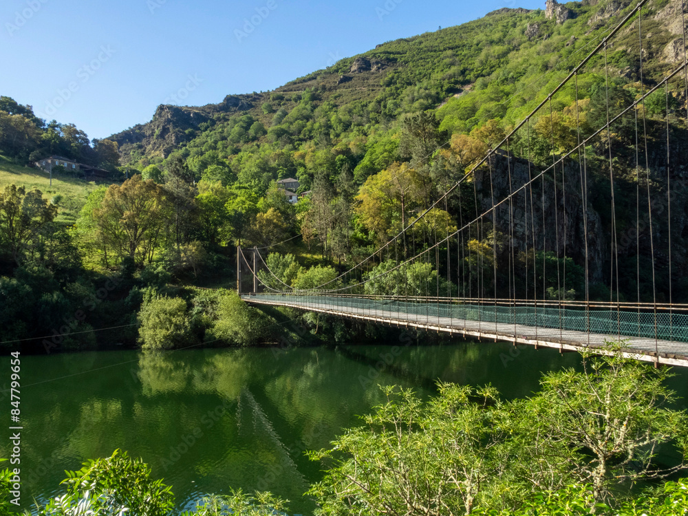 Suspension bridge in Riodeporcos over the Navia River. Border between Galicia and Asturias. Spain.