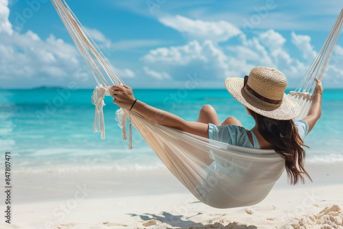 Woman relaxes in a hammock on a tropical beach, savoring her summer getaway
