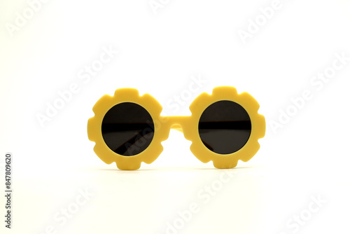 yellow flower-shaped sunglasses on a white background