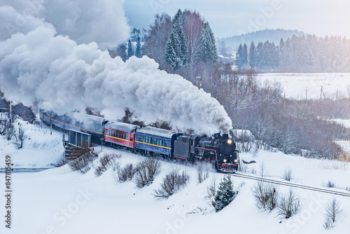 Retro steam train moves at winter morning time