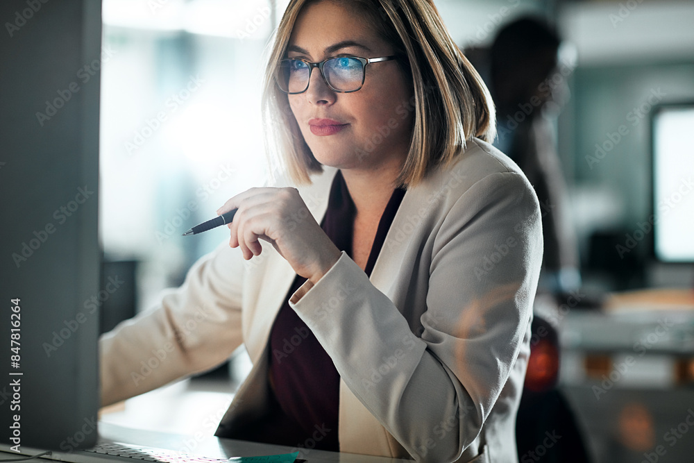 © peopleimages.com - Woman, glasses and office with research on computer, smile for career with media or press. Female journalist, happiness and workplace with online reading for news article, digital tech for report
